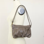 Load image into Gallery viewer, Ruche Clutch in Smoke Taupe fullgrain cowskin leather, worn short
