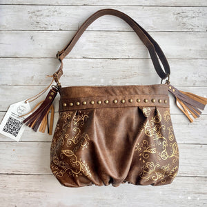 Ruche Mini Pleated Hobo in Antique Brown Leather with Gold Handpainted Floral Detail, Antique Brass Studs, and Dark Roast Tassels